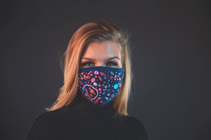 Girl with reusable face mask with candy print 